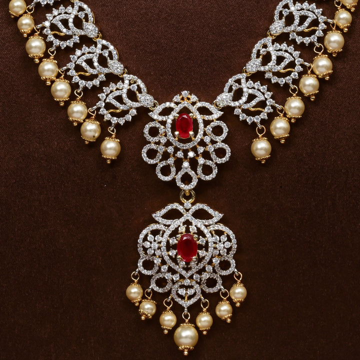Close-up of Hriday collection of 92.5 silver long necklace with CZ stones, intricate floral motifs, and pendant design for bridal and festive wear by Sri Fine Jewellery, Hyderabad.