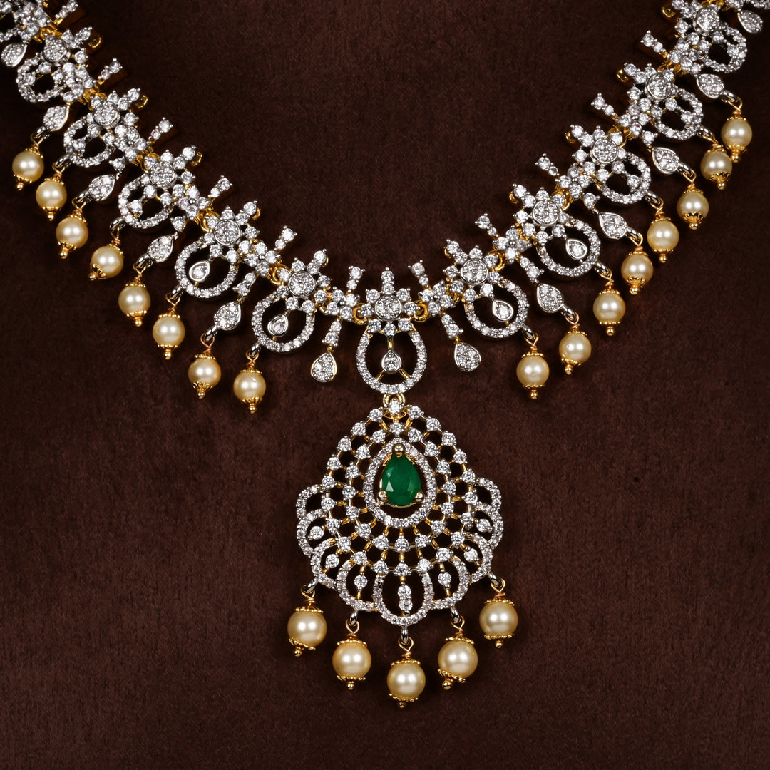 Luxury diamond-look silver cz emerald necklace with premium cz stones, semi-precious emerald stone and  pearl drops in 92.5 silver, bridal wedding jewellery with gold finish by Sri Fine Jewellery Punjagutta Hyderabad.