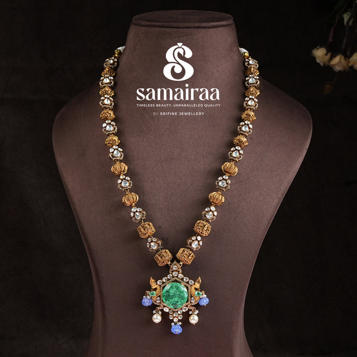 Samairaa long heritage necklace in 92.5 sterling silver with cz stones, antique gold finish, emerald green pendant and pearl drops by Sri Fine Jewellery, Hyderabad 