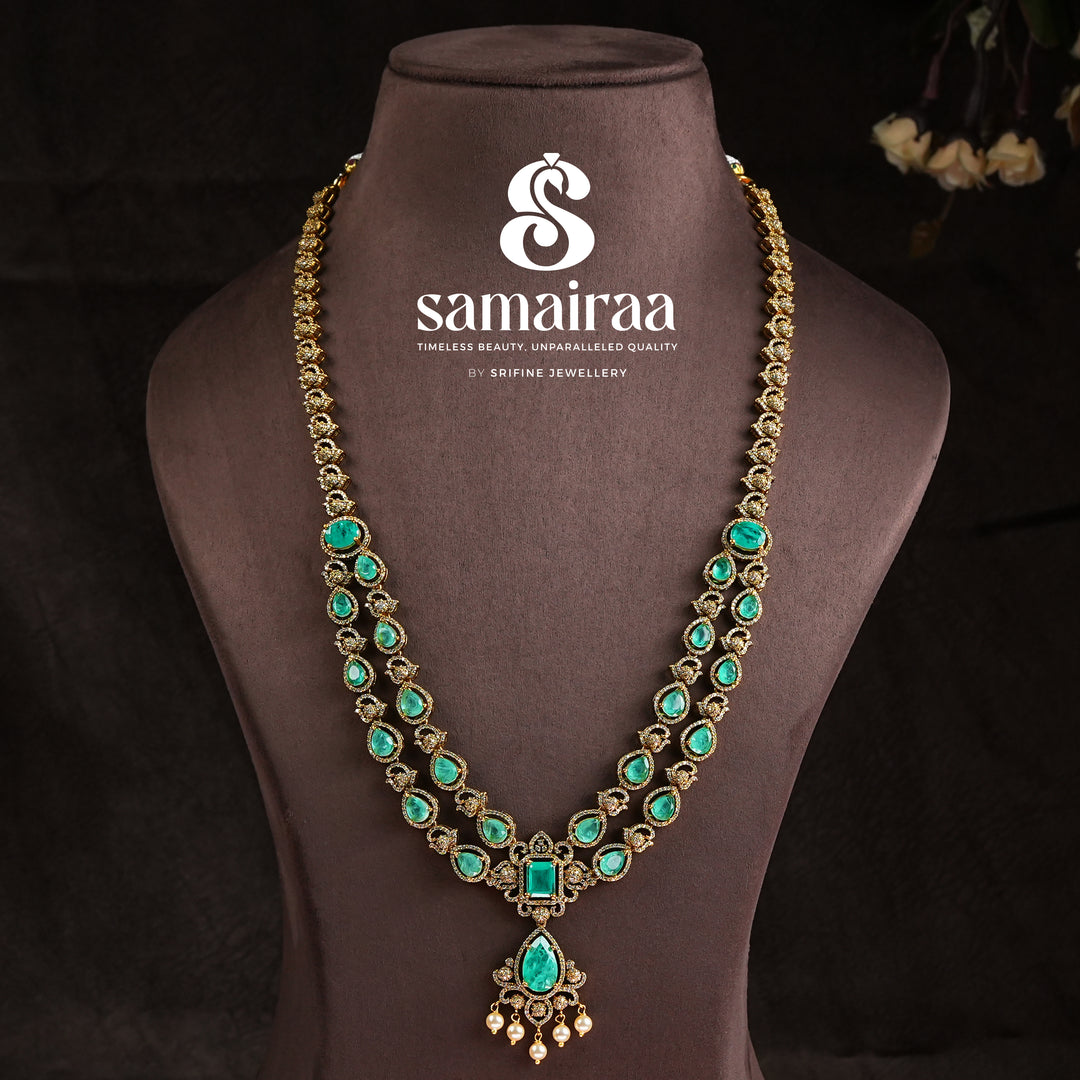 Samairaa emerald green victorian necklace set in 92.5 silver with antique gold finish, pearl hangings and royal bridal design by Sri Fine Jewellery, Hyderabad.