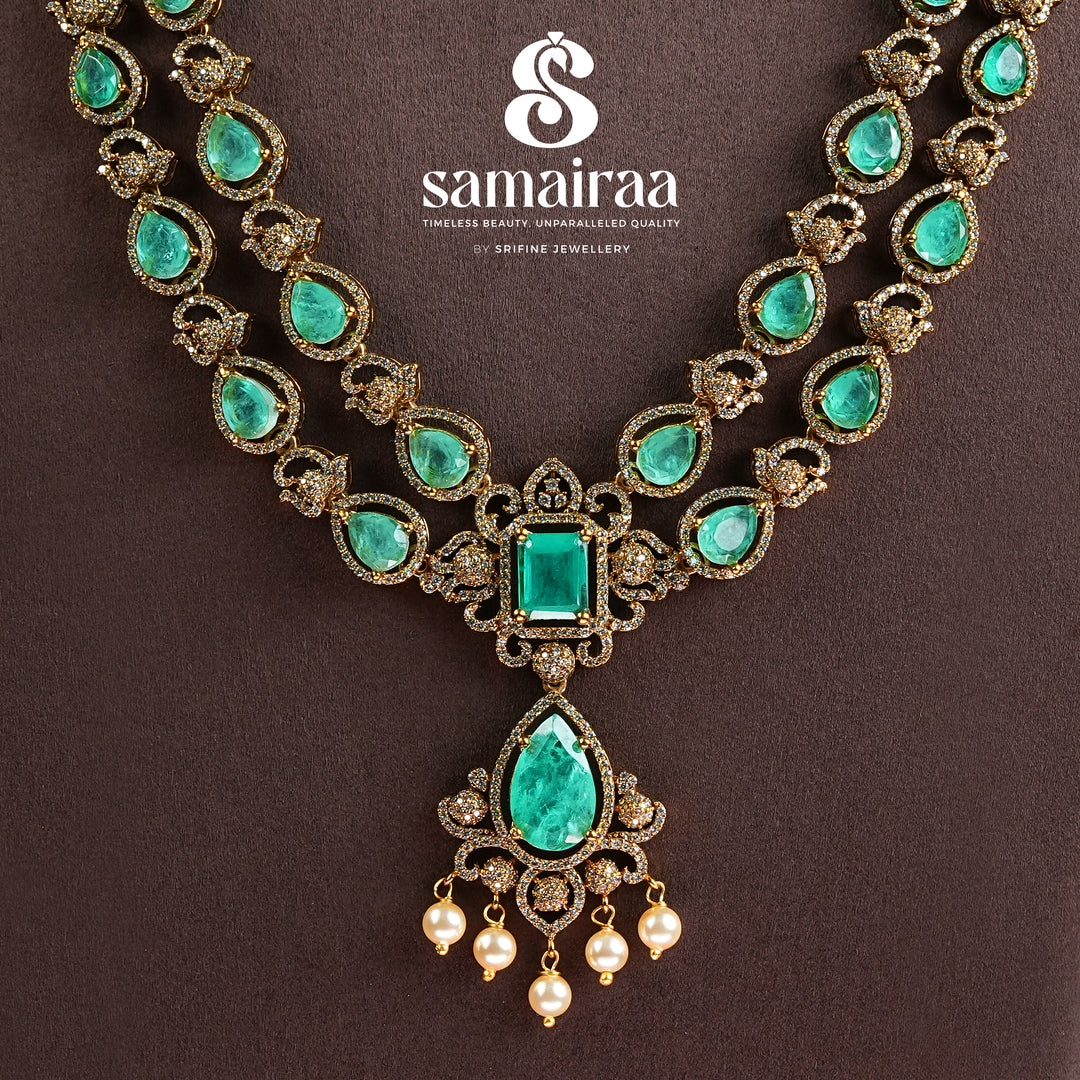 Samairaa emerald green victorian necklace in 92.5 sterling silver with antique gold finish, pearl hangings and royal bridal design by Sri Fine Jewellery, Hyderabad.