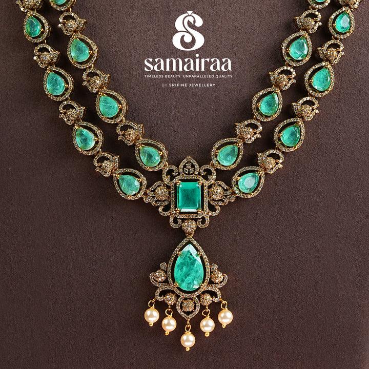 Samairaa emerald green victorian necklace in 92.5 sterling silver with antique gold finish, pearl hangings and royal bridal design by Sri Fine Jewellery, Hyderabad.