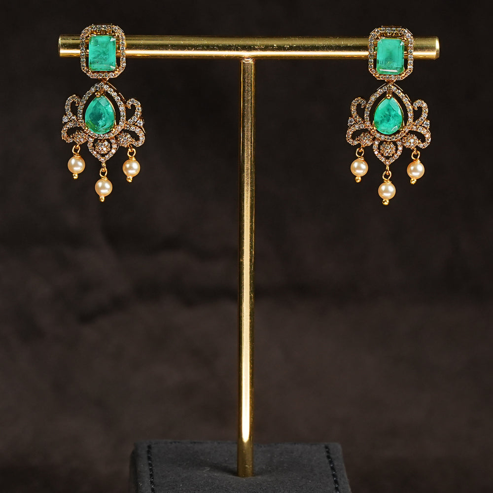 Samairaa emerald green victorian earrings in 92.5 sterling silver with antique gold finish, pearl hangings and royal bridal design by Sri Fine Jewellery, Hyderabad.