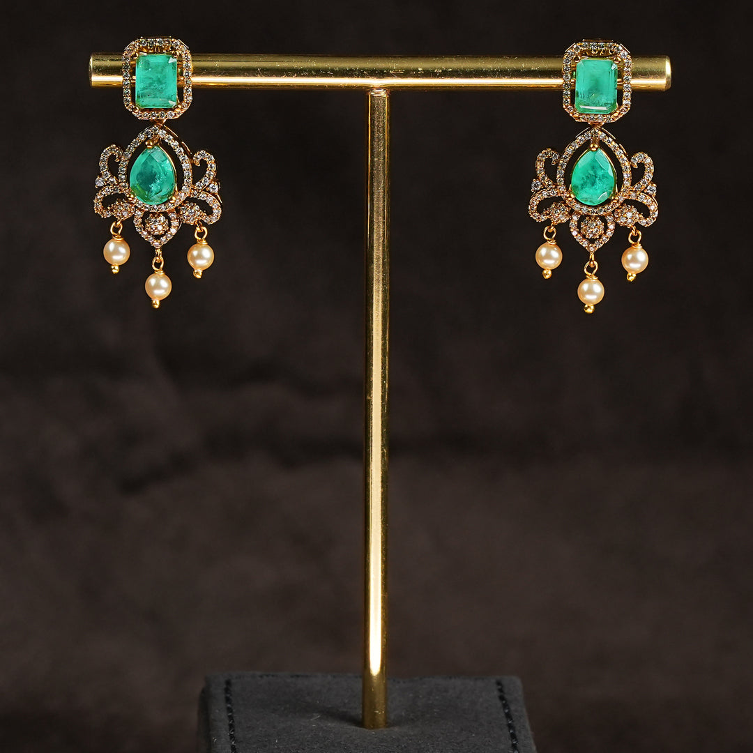 Samairaa emerald green victorian earrings in 92.5 sterling silver with antique gold finish, pearl hangings and royal bridal design by Sri Fine Jewellery, Hyderabad.