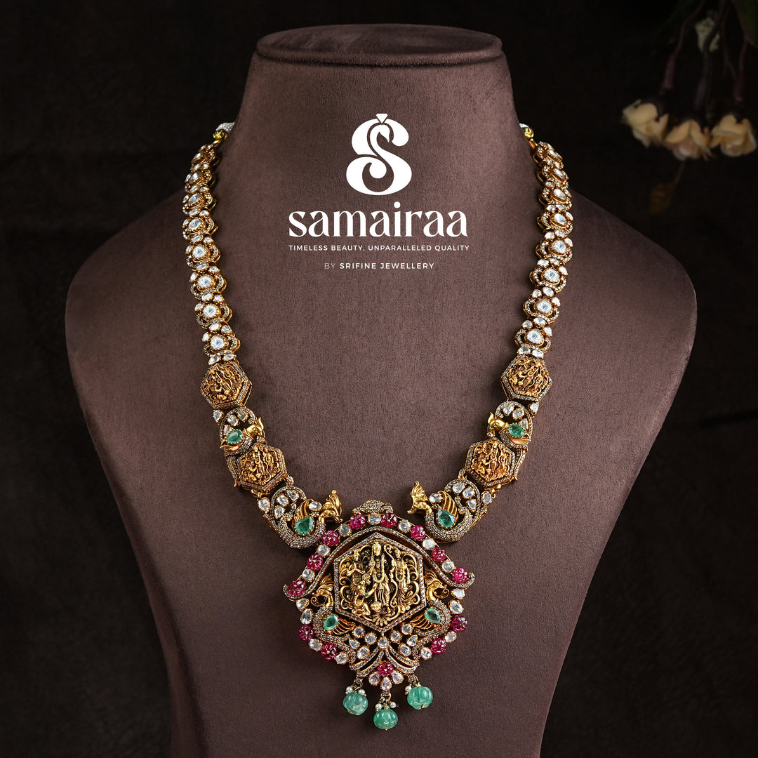 Samairaa temple necklace in 92.5 silver with Ram parivar pendant, ruby emerald stones, peacock motifs and antique South Indian bridal jewellery design by Sri Fine Jewellery, Hyderabad
