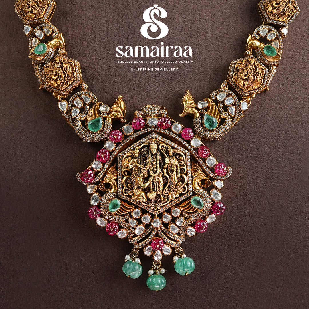 Samairaa temple necklace in 92.5 silver with Ram parivar pendant, ruby emerald stones, peacock motifs and antique South Indian bridal jewellery design by Sri Fine Jewellery, Hyderabad