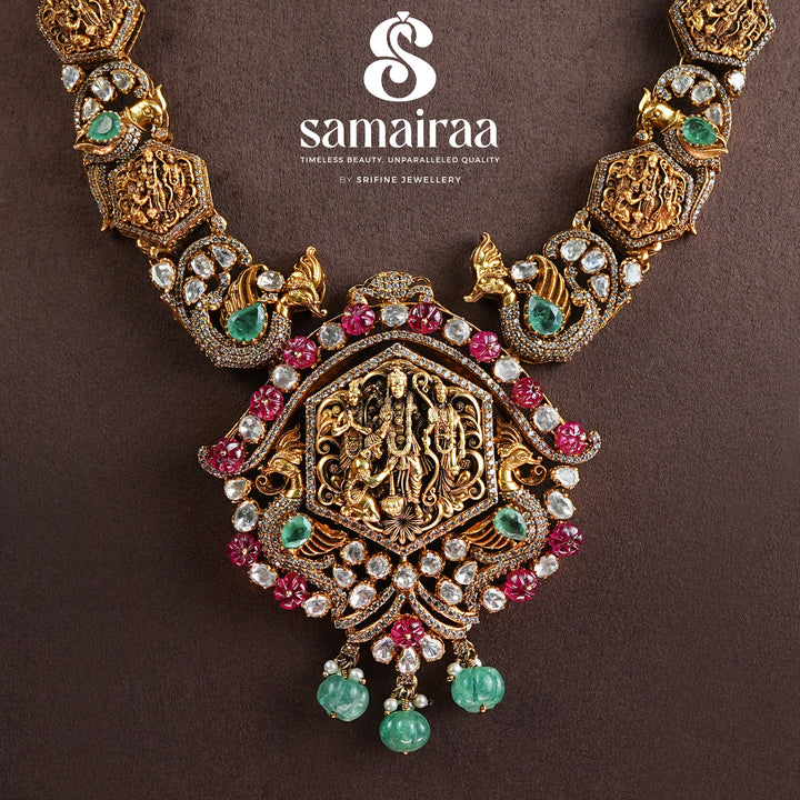 Samairaa temple necklace in 92.5 silver with Ram parivar pendant, ruby emerald stones, peacock motifs and antique South Indian bridal jewellery design by Sri Fine Jewellery, Hyderabad