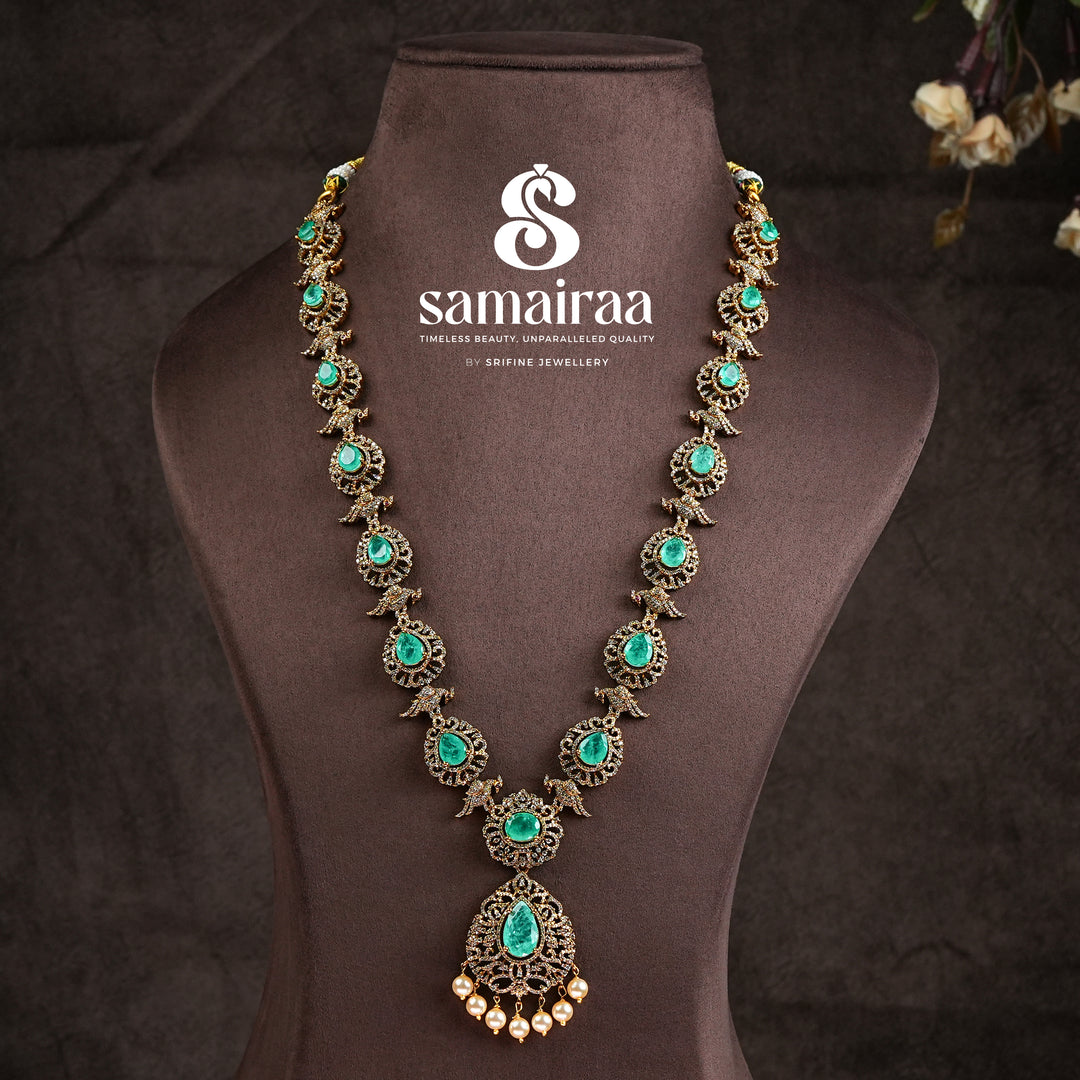 Samairaa emerald green victorian necklace in 92.5 ssilver with antique gold finish, cz stones, pearl drops and elegant bridal jewellery design by Sri Fine Jewellery, Hyderabad
