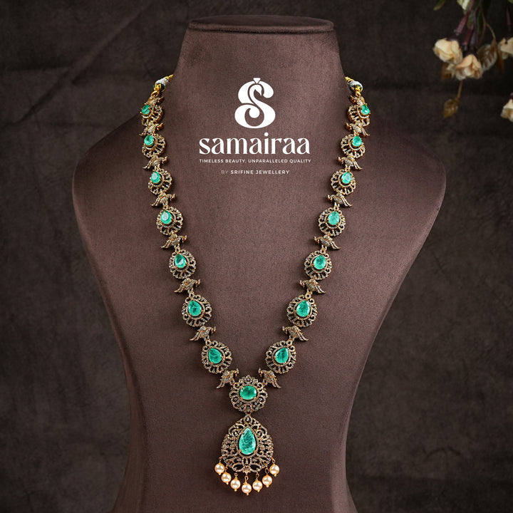 Samairaa emerald green victorian necklace in 92.5 ssilver with antique gold finish, cz stones, pearl drops and elegant bridal jewellery design by Sri Fine Jewellery, Hyderabad
