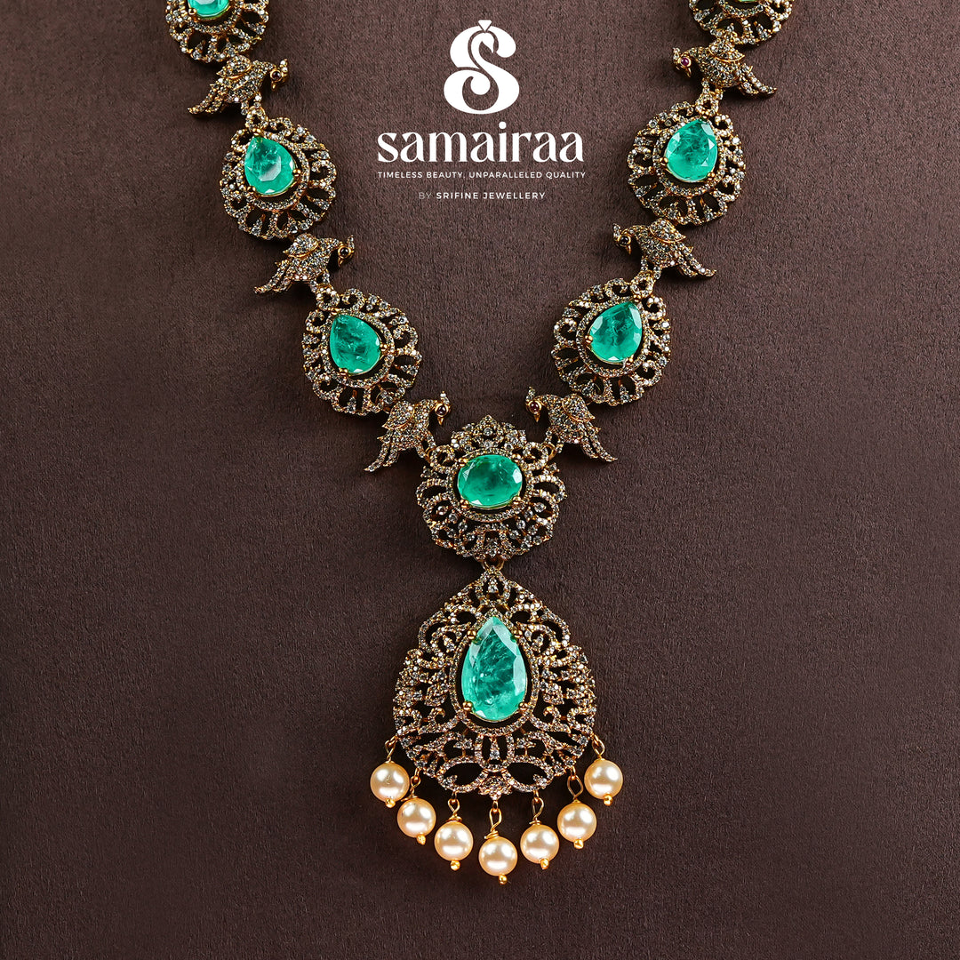 Samairaa emerald green victorian necklace in 92.5 ssilver with antique gold finish, cz stones, pearl drops and elegant bridal jewellery design by Sri Fine Jewellery, Hyderabad
