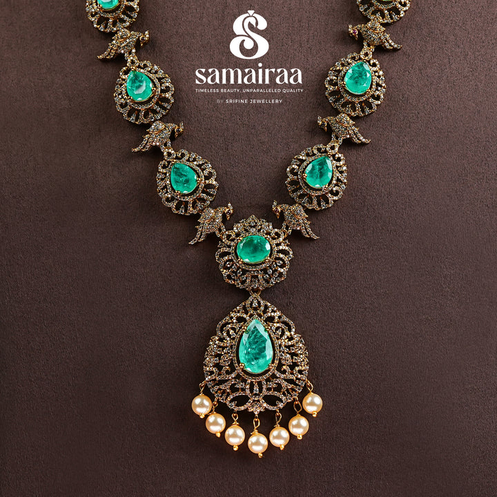 Samairaa emerald green victorian necklace in 92.5 ssilver with antique gold finish, cz stones, pearl drops and elegant bridal jewellery design by Sri Fine Jewellery, Hyderabad
