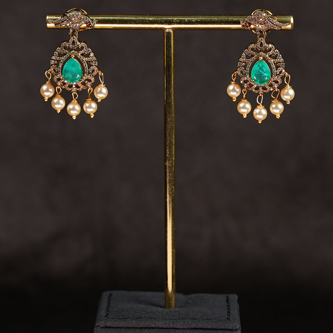 Samairaa emerald green victorian earrings in 92.5 ssilver with antique gold finish, cz stones, pearl drops and elegant bridal jewellery design by Sri Fine Jewellery, Hyderabad
