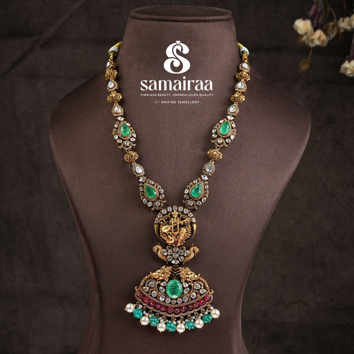 Samairaa temple necklace in 92.5 silver with Lakshmi pendant, peacock motifs, ruby emerald stones and antique bridal jewellery design by Sri Fine Jewellery, Hyderabad.
