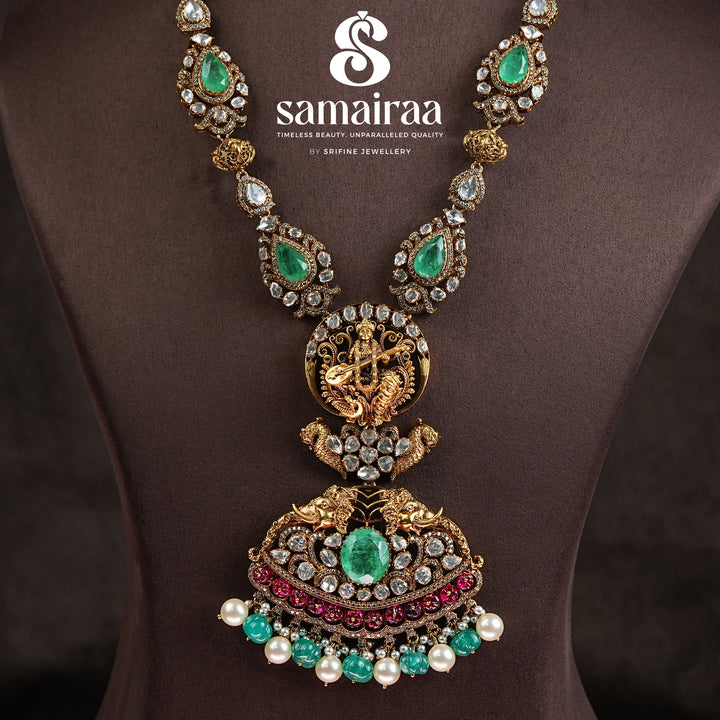 Samairaa temple necklace in 92.5 silver with Lakshmi pendant, peacock motifs, ruby emerald stones and antique bridal jewellery design by Sri Fine Jewellery, Hyderabad.
