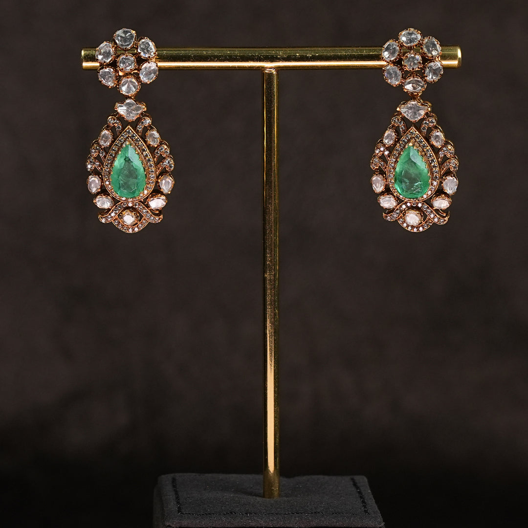 Samairaa temple earrings in 92.5 silver with Lakshmi pendant, peacock motifs, emerald stones and antique bridal jewellery design by Sri Fine Jewellery, Hyderabad.

