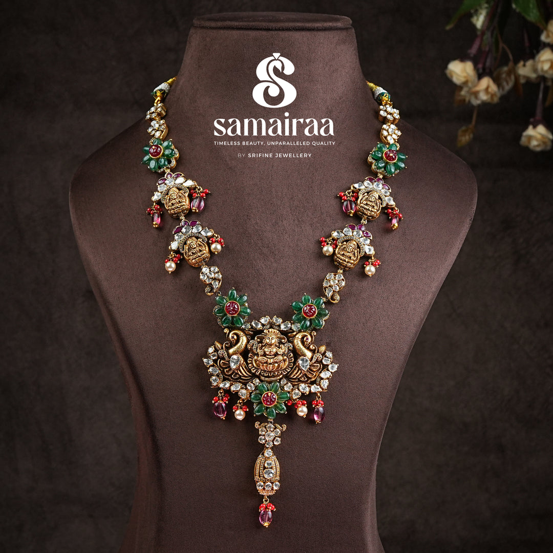 Samairaa temple necklace in 92.5 silver with Lakshmi pendant, peacock motifs, ruby emerald stones and antique bridal jewellery design by Sri Fine Jewellery, Hyderabad.
