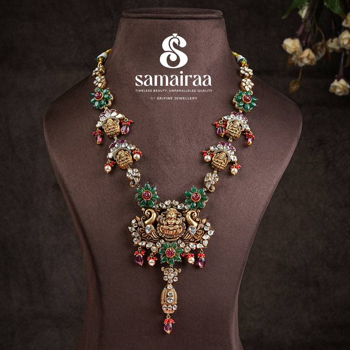 Samairaa temple necklace in 92.5 silver with Lakshmi pendant, peacock motifs, ruby emerald stones and antique bridal jewellery design by Sri Fine Jewellery, Hyderabad.
