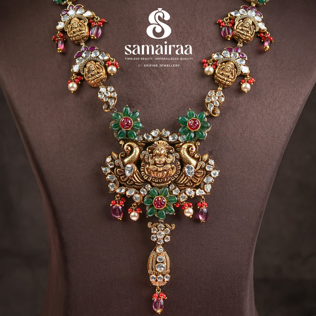 Close-up of Samairaa temple necklace in 92.5 silver with Lakshmi pendant, peacock motifs, ruby emerald stones and antique bridal jewellery design by Sri Fine Jewellery, Hyderabad.
