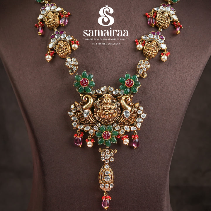 Close-up of Samairaa temple necklace in 92.5 silver with Lakshmi pendant, peacock motifs, ruby emerald stones and antique bridal jewellery design by Sri Fine Jewellery, Hyderabad.
