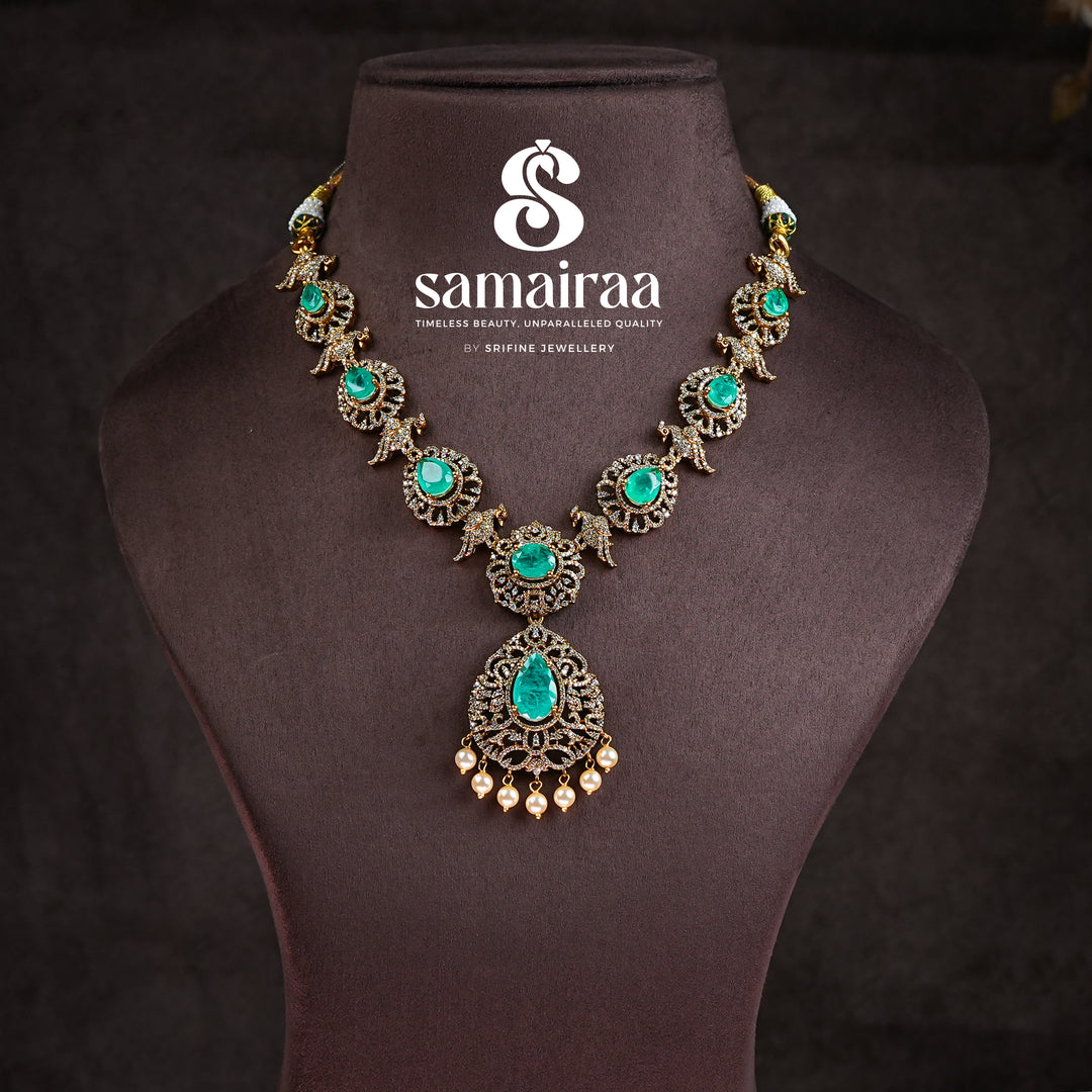 Samairaa emerald green victorian necklace in 92.5 silver with antique gold finish, cz stones, pearl drops and elegant bridal jewellery design by Sri Fine Jewellery, Hyderabad
