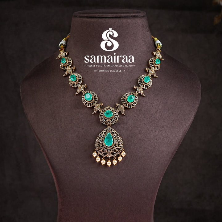 Samairaa emerald green victorian necklace in 92.5 silver with antique gold finish, cz stones, pearl drops and elegant bridal jewellery design by Sri Fine Jewellery, Hyderabad
