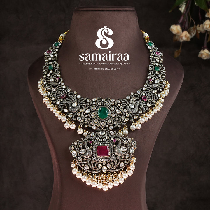 Traditional Samairaa victorian bridal necklace in 92.5 silver with emerald and ruby stones, pearl drops, antique finish and royal heritage jewellery design by Sri Fine Jewellery, Hyderabad. 
