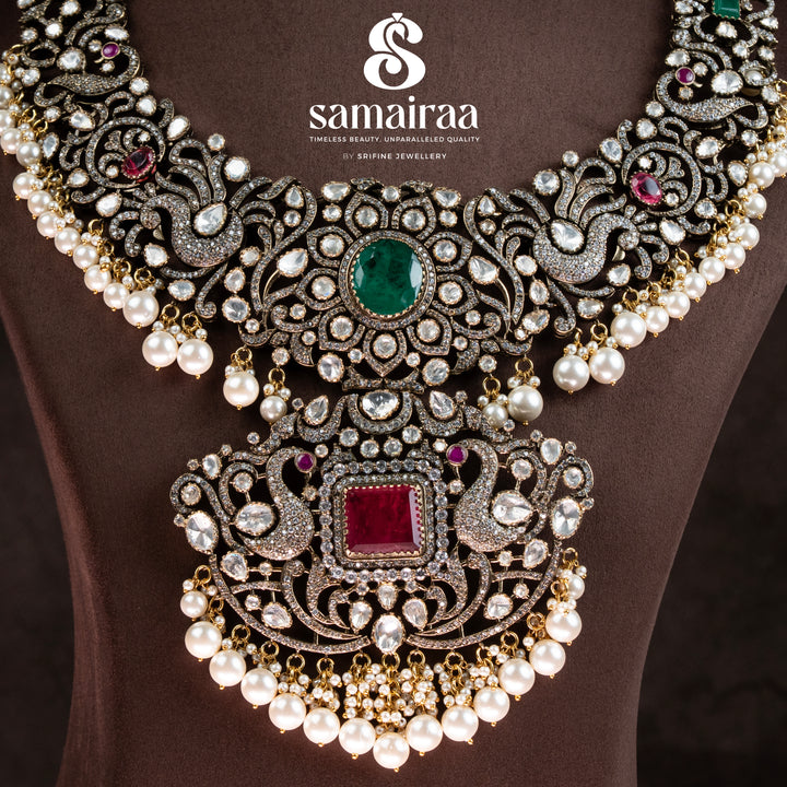 Traditional Samairaa victorian bridal necklace in 92.5 silver with emerald and ruby stones, pearl drops, antique finish and royal heritage jewellery design by Sri Fine Jewellery, Hyderabad. 