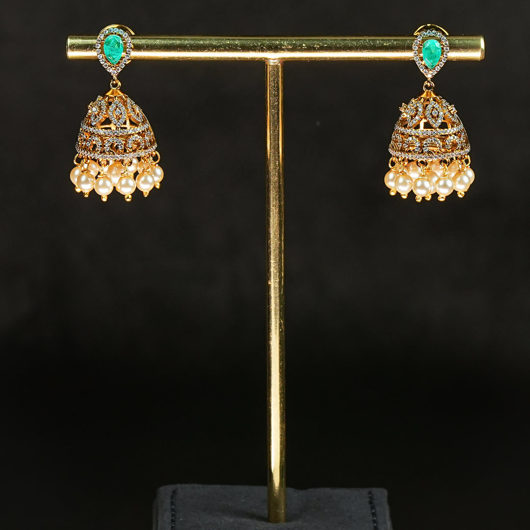 Traditional Samairaa emerald green victorian jhumka earrings in 92.5 silver with antique gold finish, pearl hangings and royal bridal design by Sri Fine Jewellery, Hyderabad.