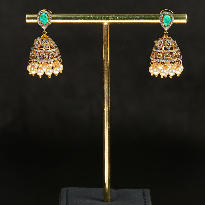 Traditional Samairaa emerald green victorian jhumka earrings in 92.5 silver with antique gold finish, pearl hangings and royal bridal design by Sri Fine Jewellery, Hyderabad.