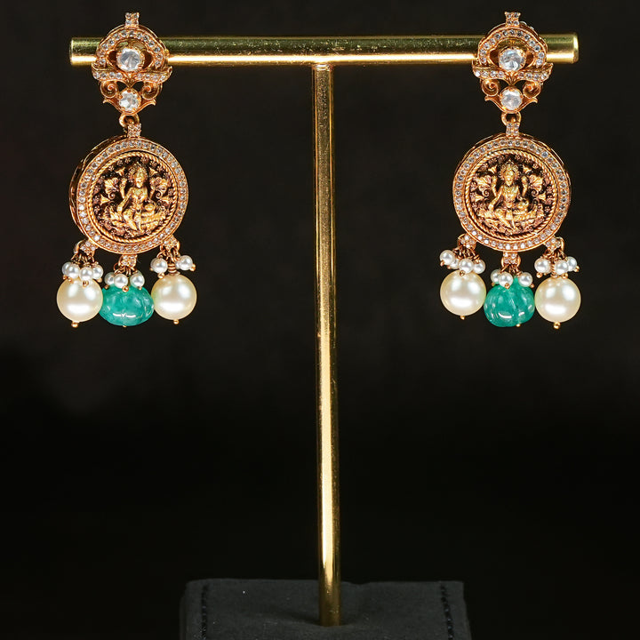 Samairaa antique coin earrings in 92.5 silver with emerald green center stone, Lakshmi coin motifs, pearl drops and cz detailing | premium temple bridal jewellery by Sri Fine Jewellery, Hyderabad