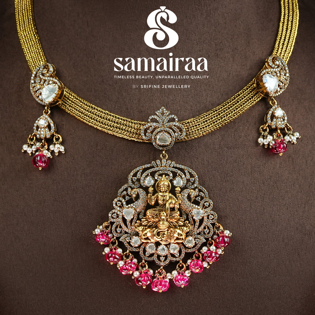 Close-up view of traditional Samairaa temple pendant necklace in 92.5 silver with goddess Lakshmi motif, antique gold finish, pink stone drops and cz detailing | traditional bridal temple jewellery by Sri Fine Jewellery, Hyderabad 
