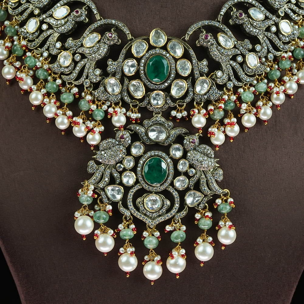 Close-up view of samairaa Victorian moissanite necklace in 92.5 sterling silver with semi-precious emerald green stones, pearl drops and cz detailing | luxurious bridal statement jewellery by Sri Fine Jewellery, Hyderabad

