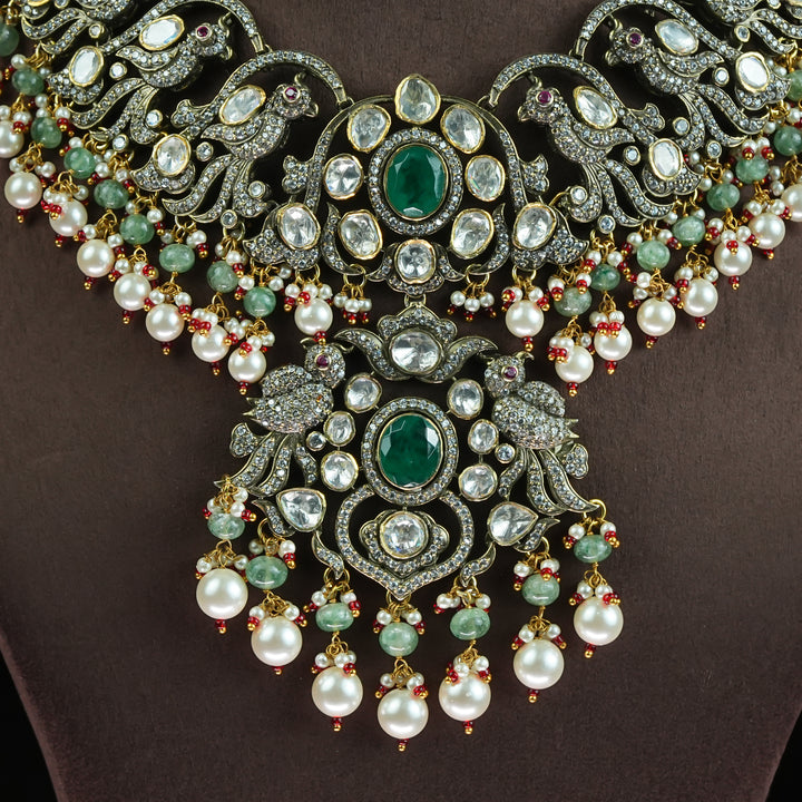 Close-up view of samairaa Victorian moissanite necklace in 92.5 sterling silver with semi-precious emerald green stones, pearl drops and cz detailing | luxurious bridal statement jewellery by Sri Fine Jewellery, Hyderabad
