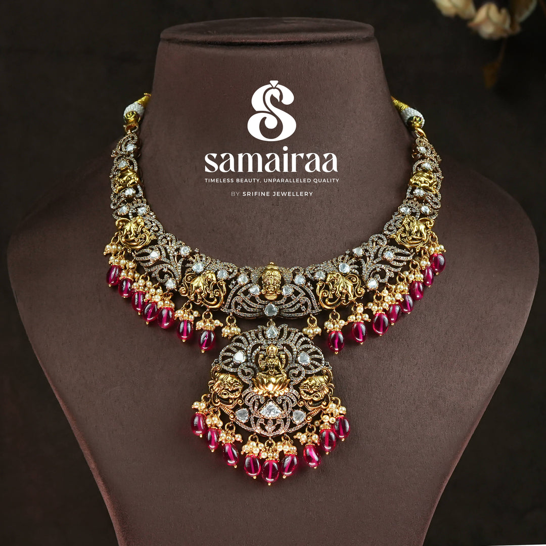 Trational antique victorian 92.5 silver necklace with Lakshmi pendant, cz stone detailing, ruby bead drops and traditional South Indian bridal jewellery design by Sri Fine Jewellery Hyderabad.
