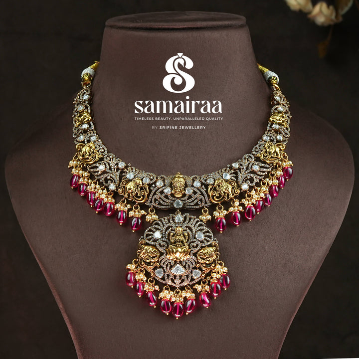 Trational antique victorian 92.5 silver necklace with Lakshmi pendant, cz stone detailing, ruby bead drops and traditional South Indian bridal jewellery design by Sri Fine Jewellery Hyderabad.
