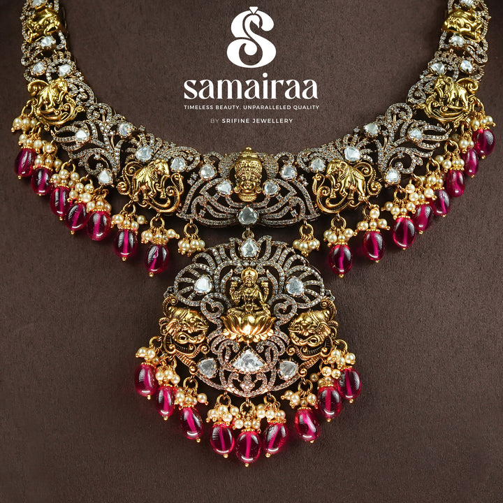Trational antique victorian 92.5 silver necklace with Lakshmi pendant, cz stone detailing, ruby bead drops and traditional South Indian bridal jewellery design by Sri Fine Jewellery Hyderabad.
