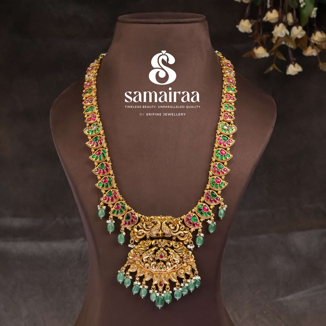 Traditional South Indian temple silver necklace with antique gold finish, Lakshmi pendant, ruby emerald stones and green bead drops for bridal jewellery by Sri Fine Jewellery Hyderabad.
