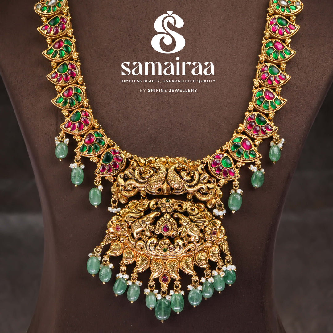 Traditional South Indian temple silver necklace with antique gold finish, Lakshmi pendant, ruby emerald stones and green bead drops for bridal jewellery by Sri Fine Jewellery Hyderabad.