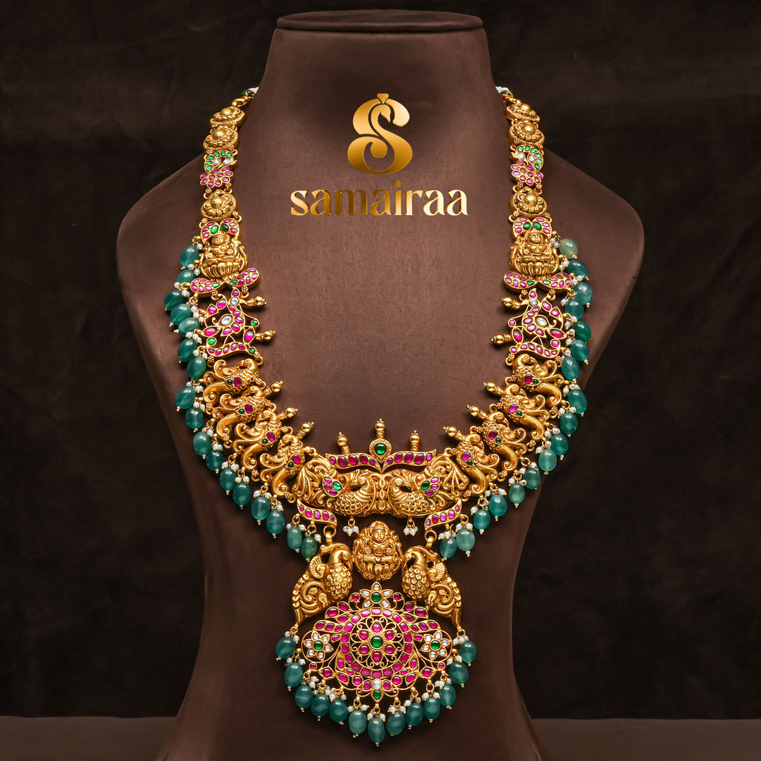 Traditional antique temple 92.5 silver necklace with peacock motifs, Lakshmi pendant, green bead drops, kundan stones and traditional South Indian bridal jewellery design by Sri Fine Jewellery Hyderabad.