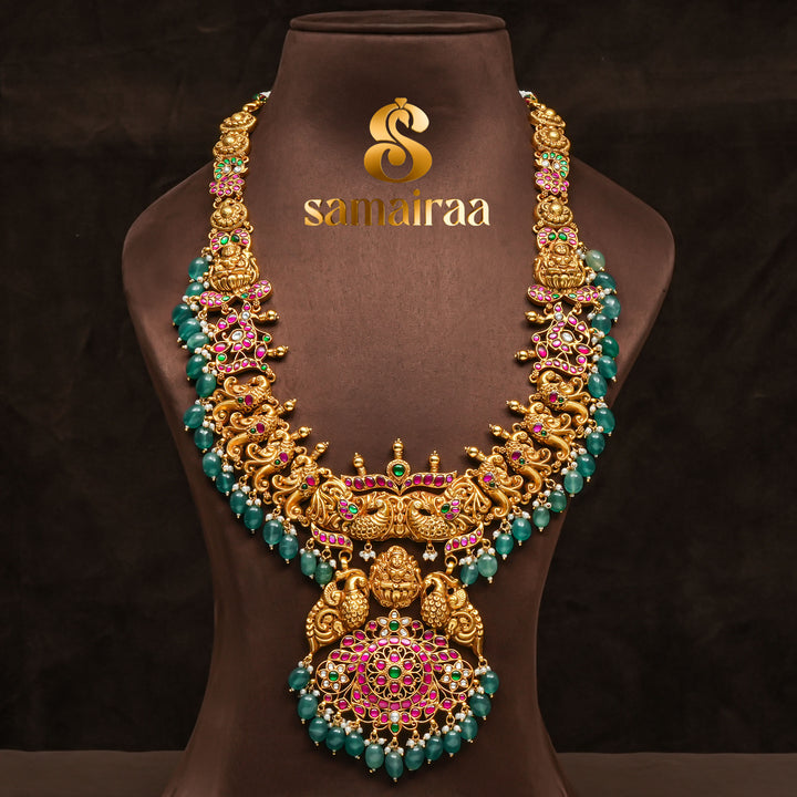 Traditional antique temple 92.5 silver necklace with peacock motifs, Lakshmi pendant, green bead drops, kundan stones and traditional South Indian bridal jewellery design by Sri Fine Jewellery Hyderabad.