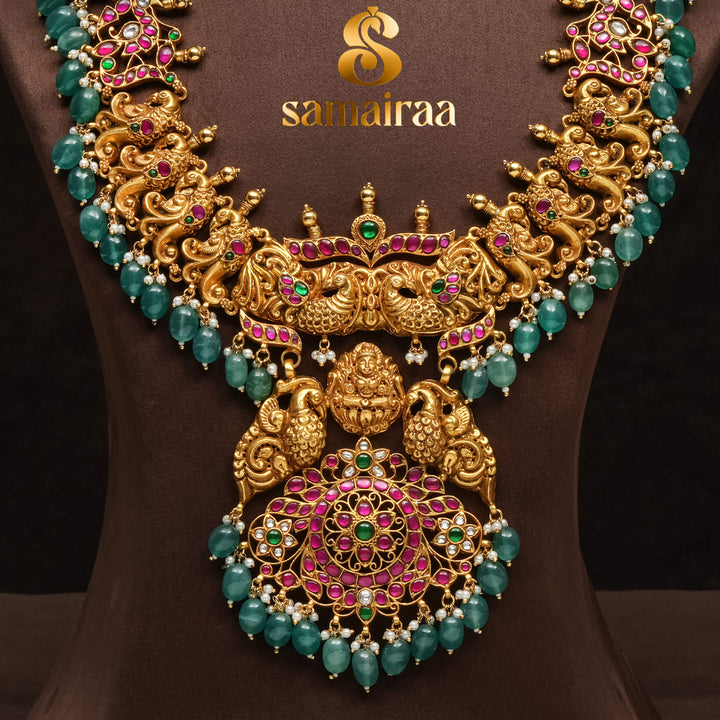 Traditional antique temple 92.5 silver necklace with peacock motifs, Lakshmi pendant, green bead drops, kundan stones and traditional South Indian bridal jewellery design by Sri Fine Jewellery Hyderabad.