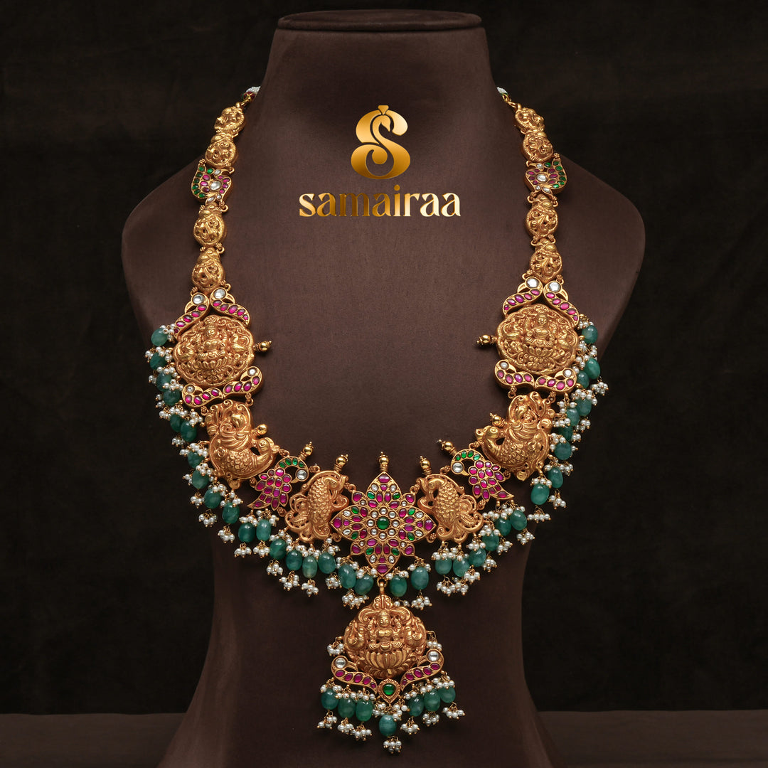 Traditional antique temple silver necklace with peacock motifs, Lakshmi pendant, green bead drops, kundan stones and traditional South Indian bridal jewellery design by Sri Fine Jewellery Hyderabad.

