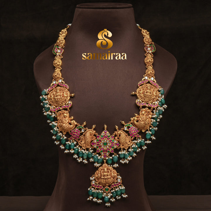 Traditional antique temple silver necklace with peacock motifs, Lakshmi pendant, green bead drops, kundan stones and traditional South Indian bridal jewellery design by Sri Fine Jewellery Hyderabad.
