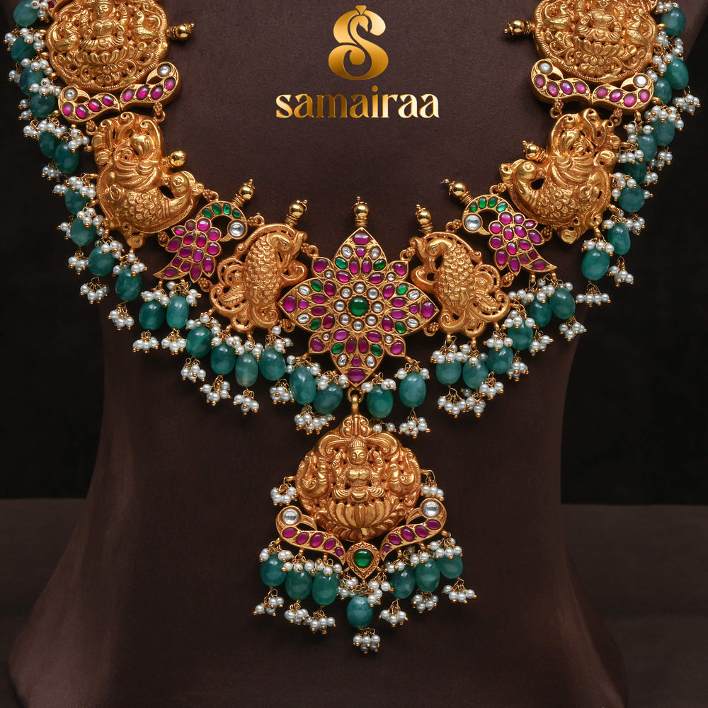 Traditional antique temple silver necklace with peacock motifs, Lakshmi pendant, green bead drops, kundan stones and traditional South Indian bridal jewellery design by Sri Fine Jewellery Hyderabad.