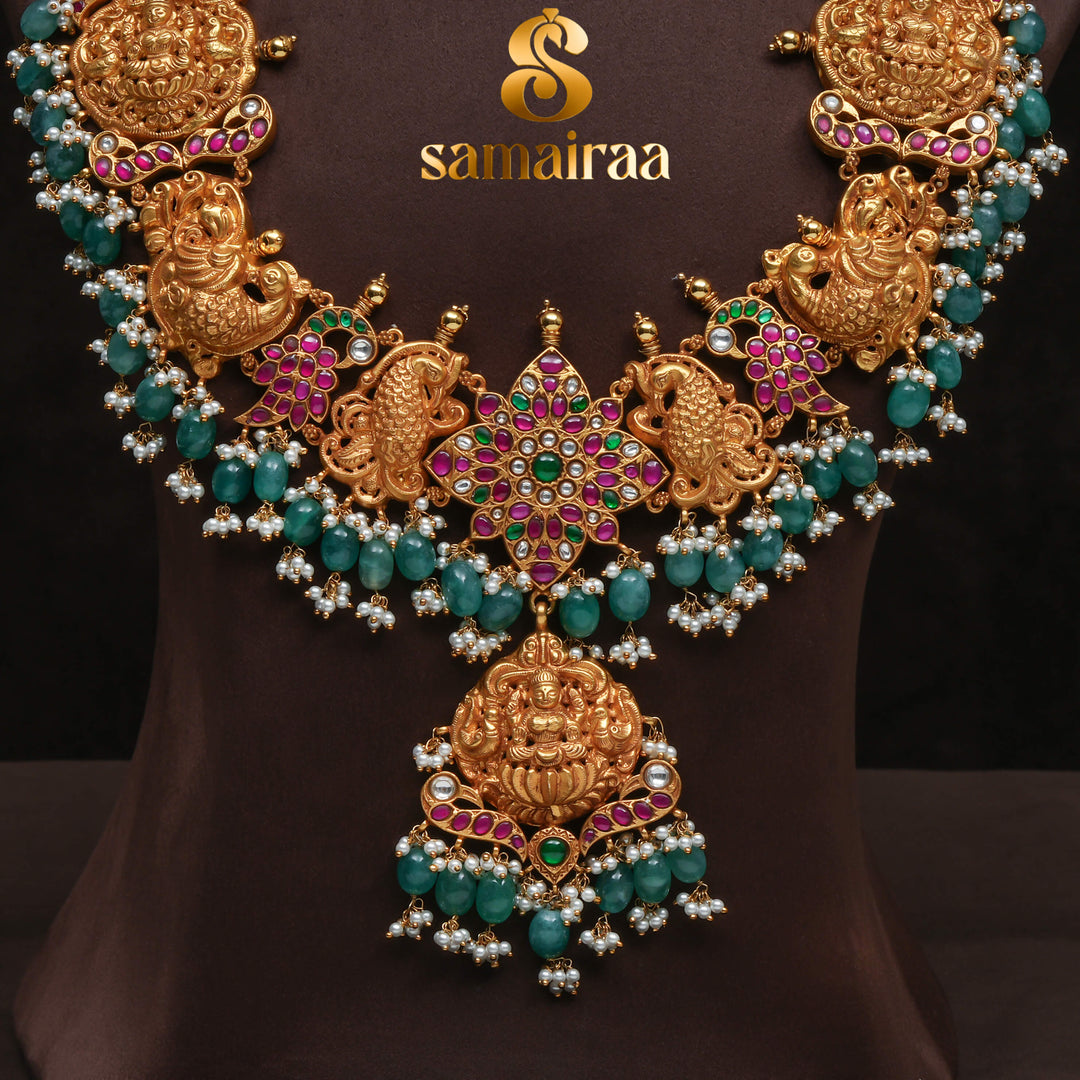 Traditional antique temple silver necklace with peacock motifs, Lakshmi pendant, green bead drops, kundan stones and traditional South Indian bridal jewellery design by Sri Fine Jewellery Hyderabad.