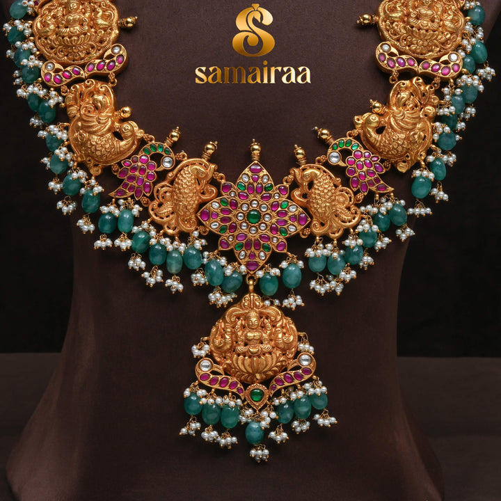 Traditional antique temple silver necklace with peacock motifs, Lakshmi pendant, green bead drops, kundan stones and traditional South Indian bridal jewellery design by Sri Fine Jewellery Hyderabad.