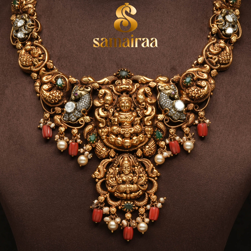 Traditional temple 92.5 silver necklace with antique gold polish, Lakshmi goddess pendant, ruby and emerald stones, pearl drops and South Indian bridal jewellery design by Sri Fine Jewellery Hyderabad.