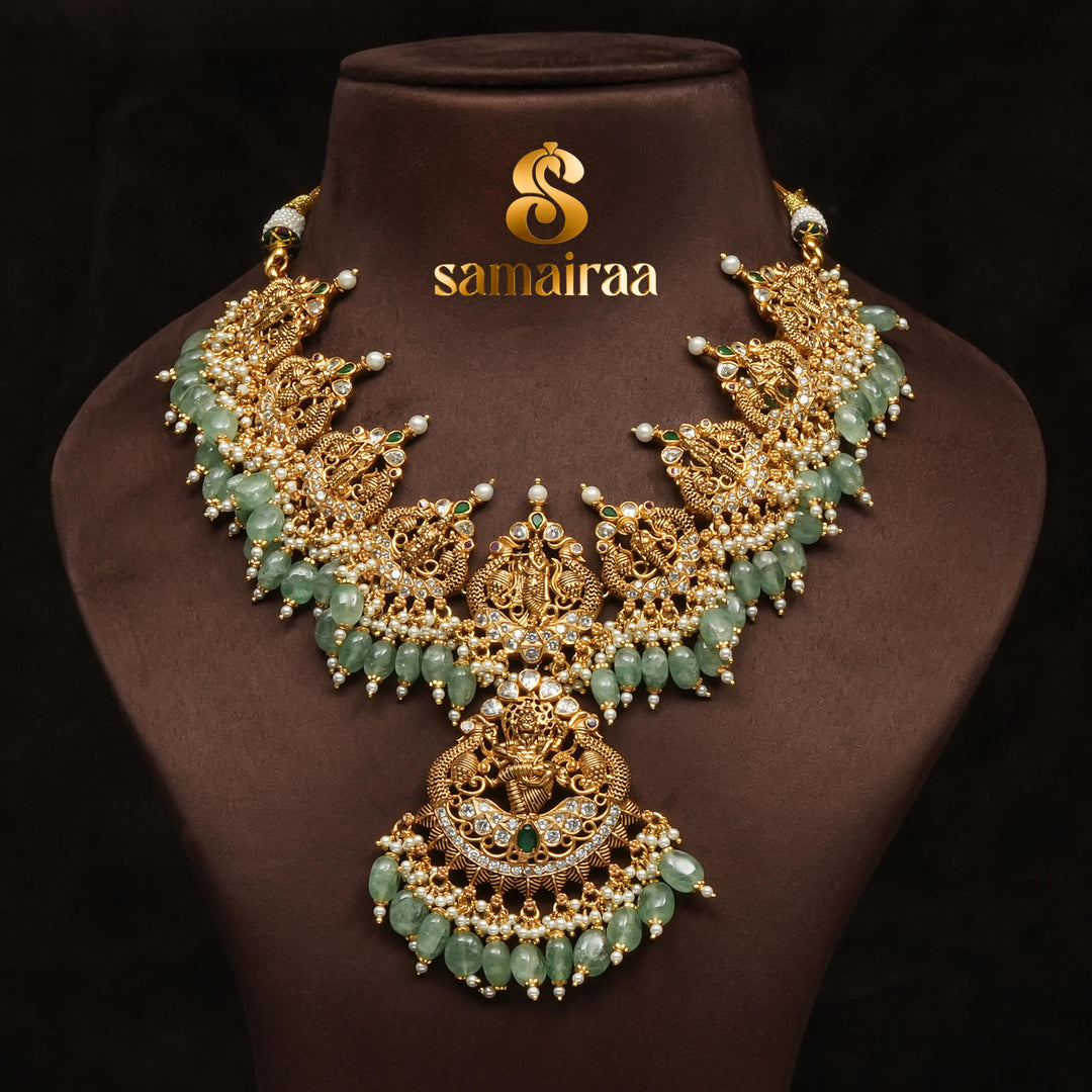 Traditional antique temple silver necklace with green jade beads, Lakshmi pendant, pearl detailing and traditional South Indian bridal jewellery design by Sri Fine Jewellery Hyderabad.
