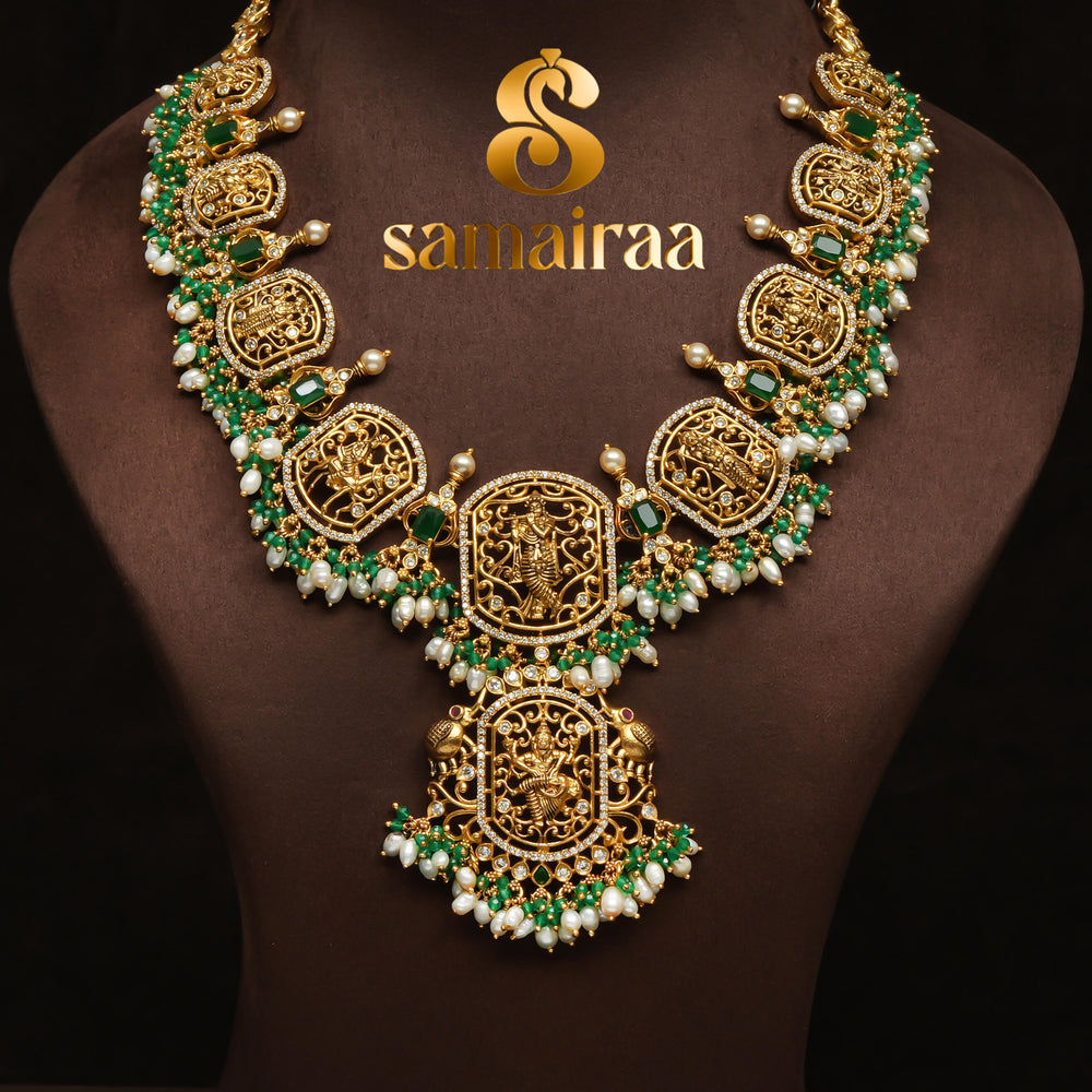 Traditional temple 92.5 silver necklace with antique gold finish, pearl drops, emerald stones and intricate Krishna pendant design by Sri Fine Jewellery, Hyderabad.
