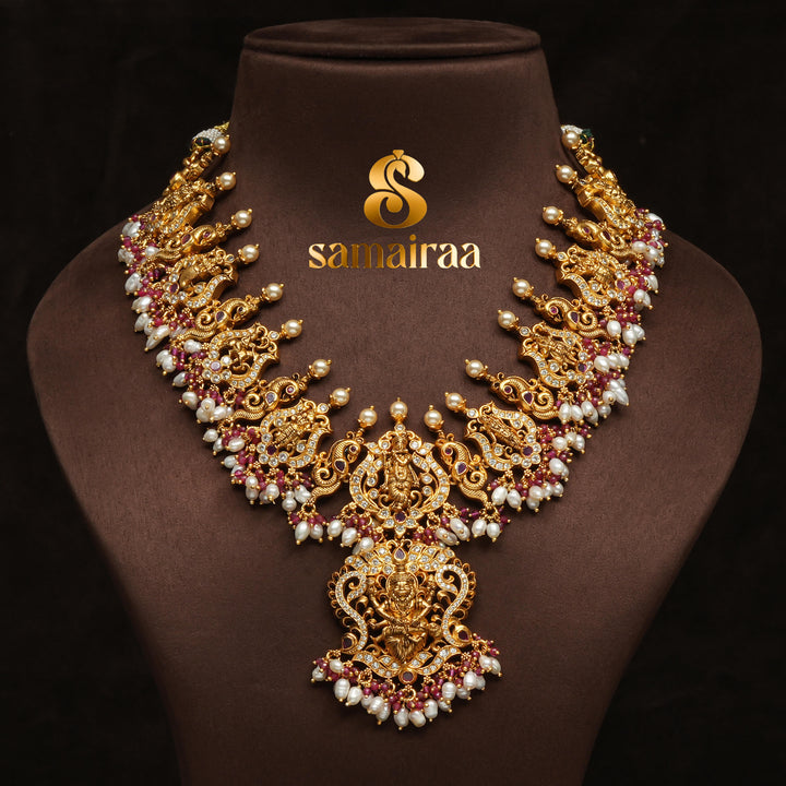 Traditional temple silver necklace with antique gold finish, pearl drops, pink ruby stones and intricate Lakshmi pendant design by Sri Fine Jewellery Hyderabad.
